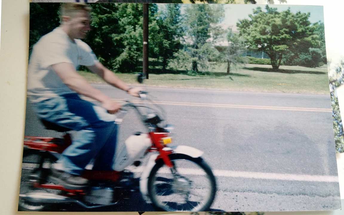 Picture of Tony riding a moped.